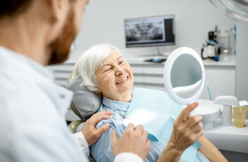 Elderly woman enjoying her smile in the dental office